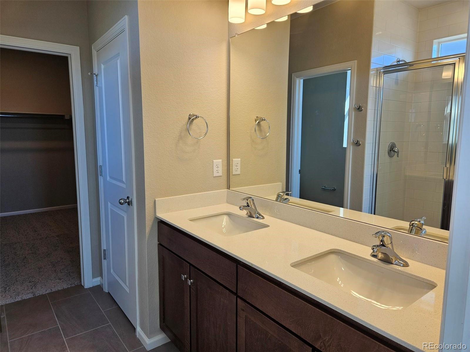 6028 Keyser Place Brighton, CO 80601 - Photo 11 of 14 a bathroom with a sink and a mirror