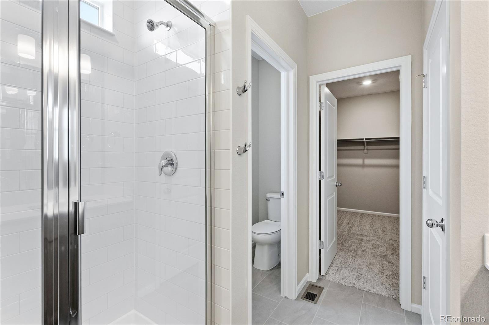 6028 Keyser Place Brighton, CO 80601 - Photo 13 of 26 a bathroom with a glass door shower