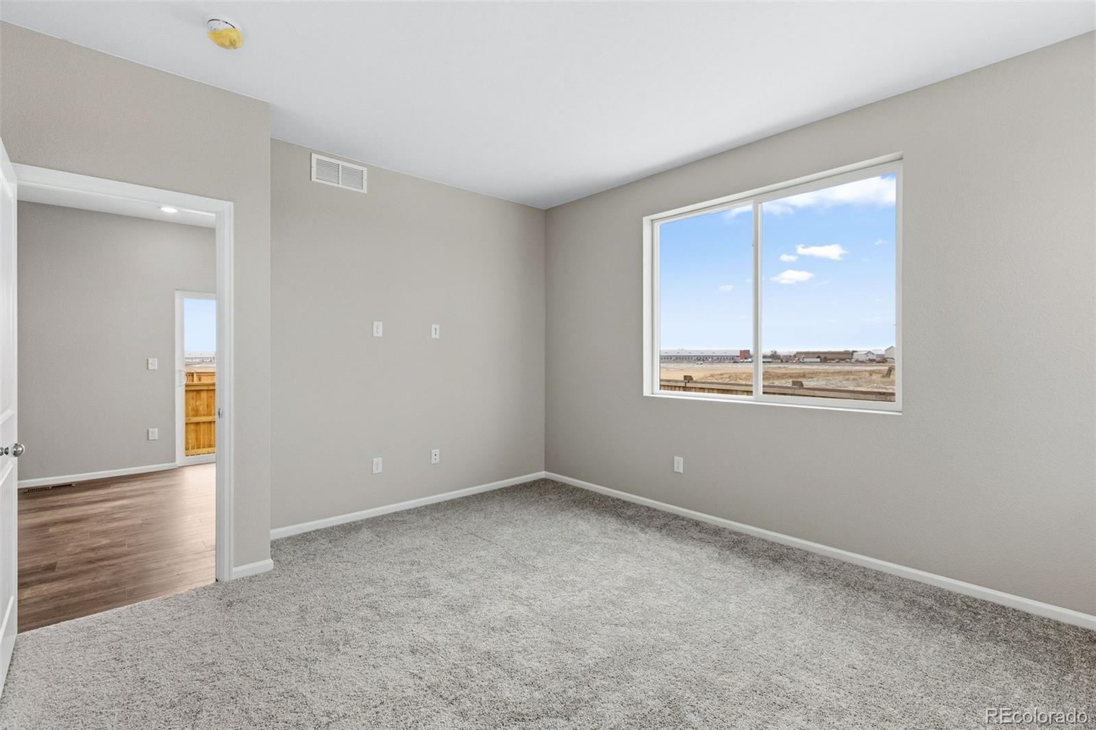 6028 Keyser Place Brighton, CO 80601 - Photo 18 of 26 an empty room with windows