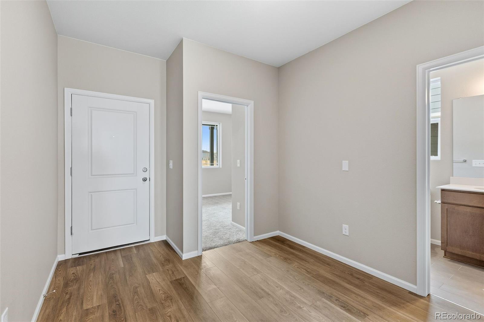 6028 Keyser Place Brighton, CO 80601 - Photo 20 of 26 wooden floor in an empty room with a window