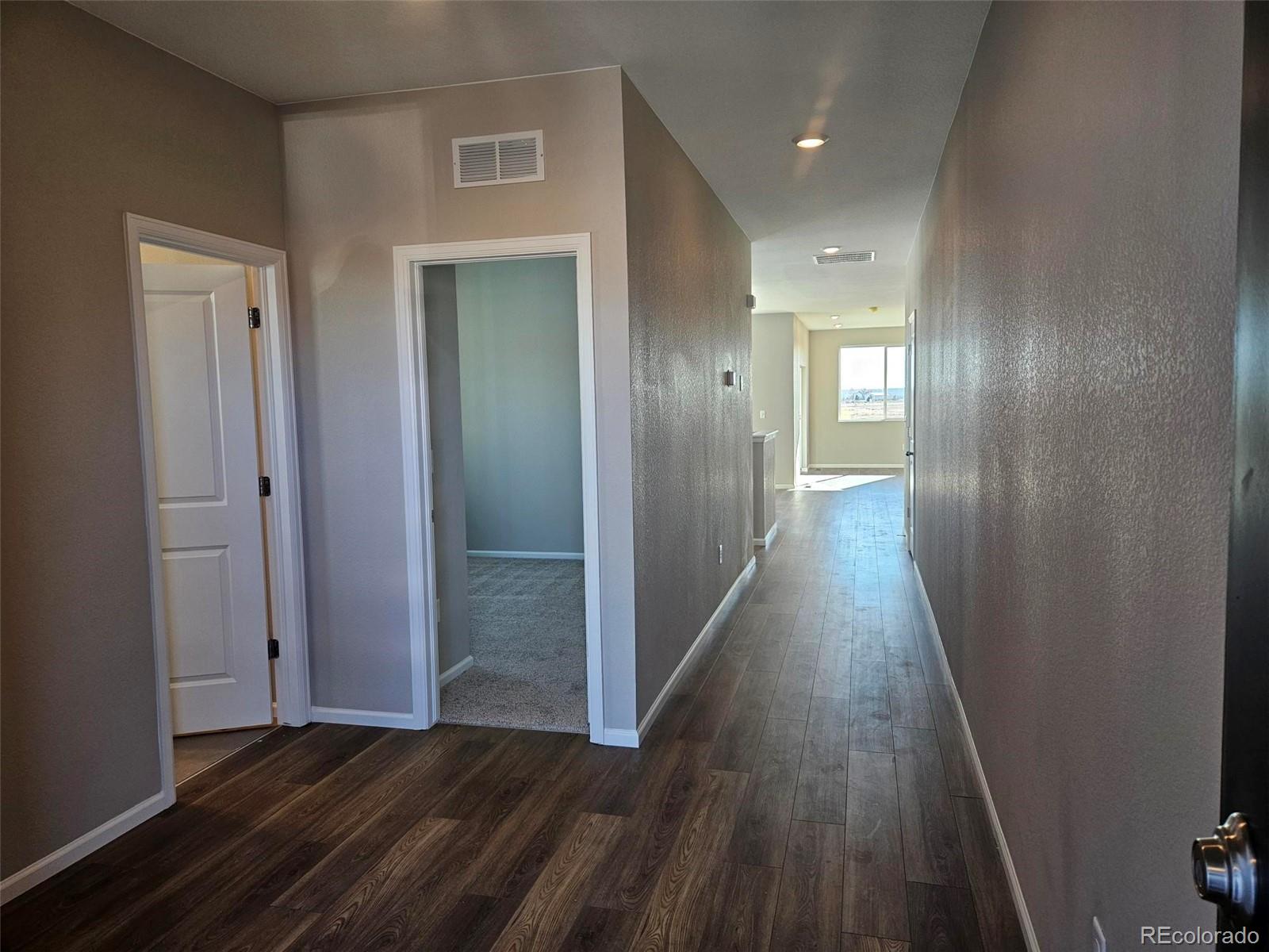 6028 Keyser Place Brighton, CO 80601 - Photo 2 of 14 a view of a hallway with wooden floor