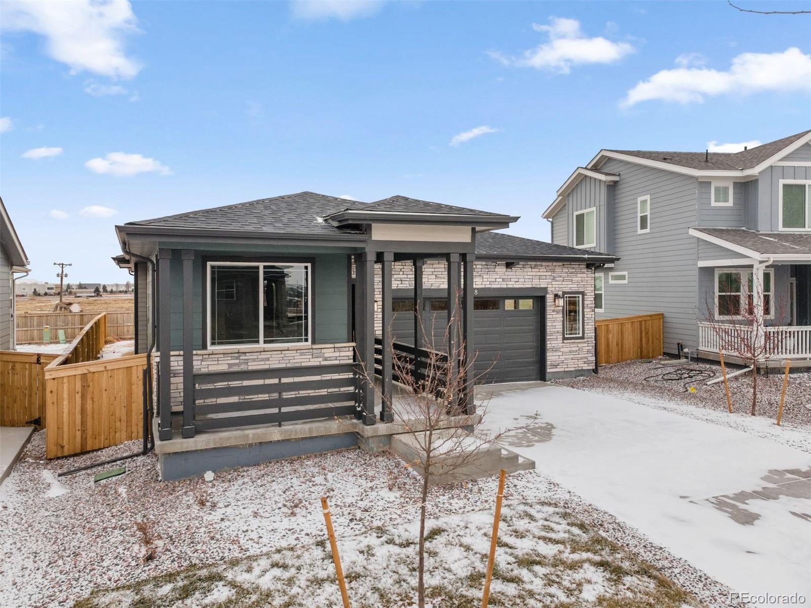 6028 Keyser Place Brighton, CO 80601 - Photo 25 of 26 a front view of a house with outdoor seating