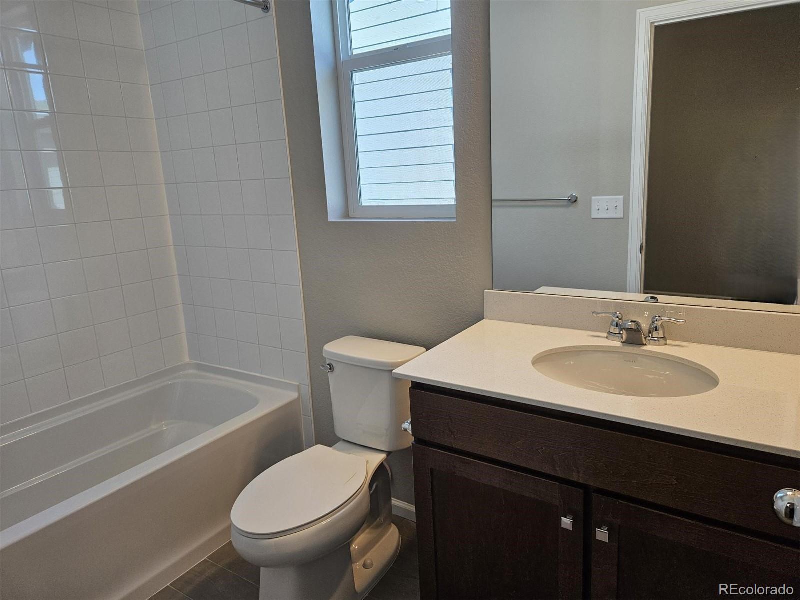 6028 Keyser Place Brighton, CO 80601 - Photo 4 of 14 a bathroom with a sink toilet and a bathtub