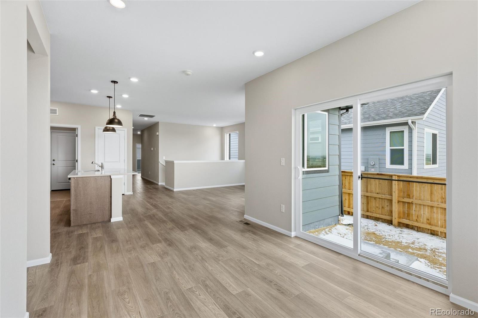 6028 Keyser Place Brighton, CO 80601 - Photo 7 of 26 a view of a big room with wooden floor and windows