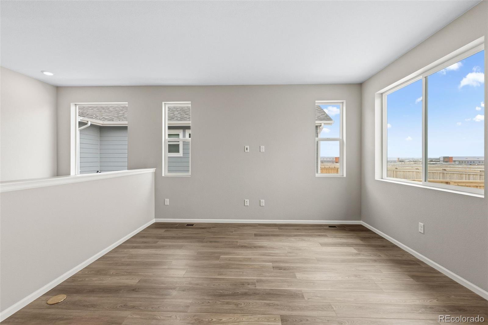 6028 Keyser Place Brighton, CO 80601 - Photo 8 of 26 wooden floor in an empty room with a window