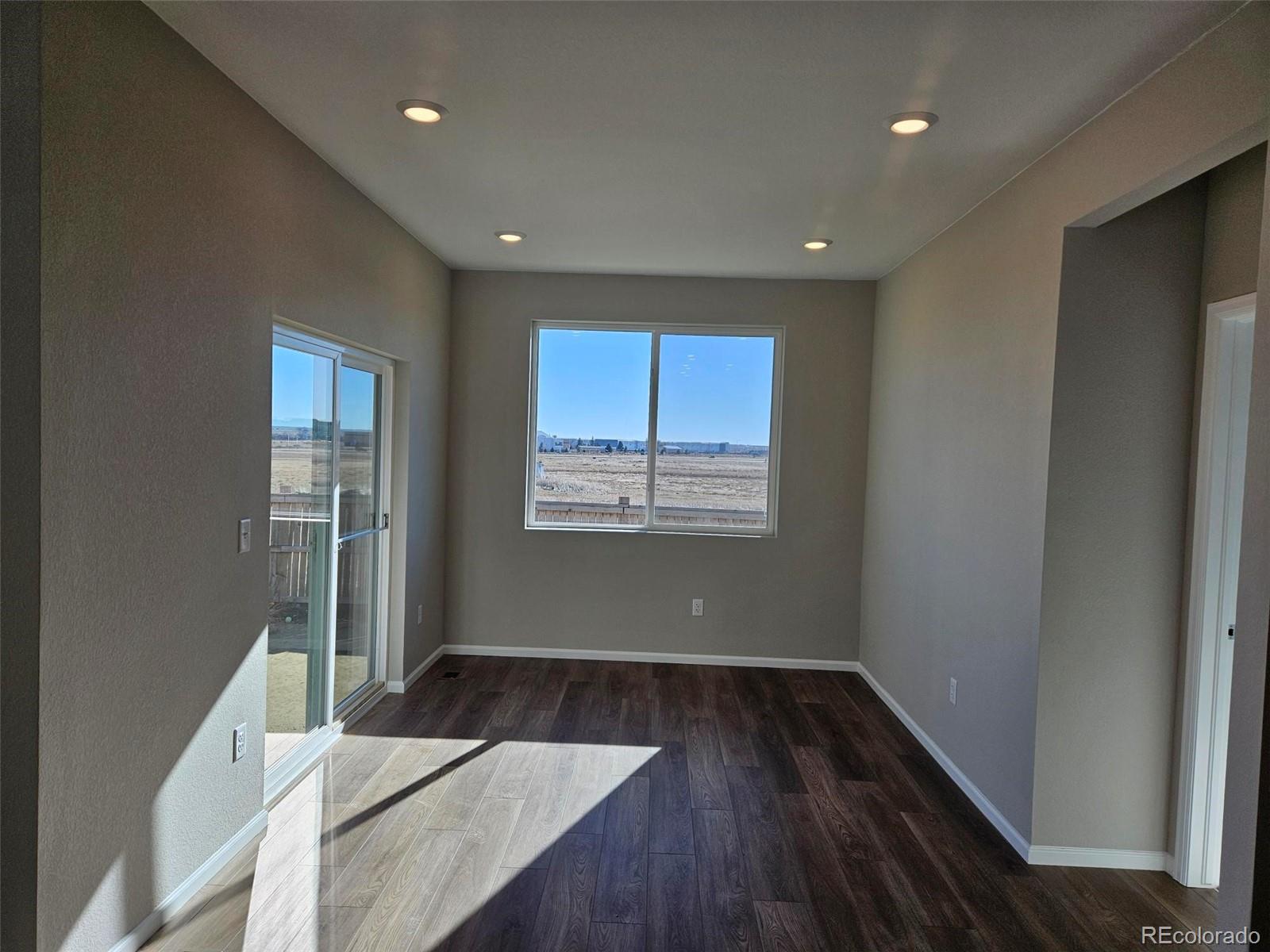 6028 Keyser Place Brighton, CO 80601 - Photo 9 of 14 a view of a room with wooden floor and window