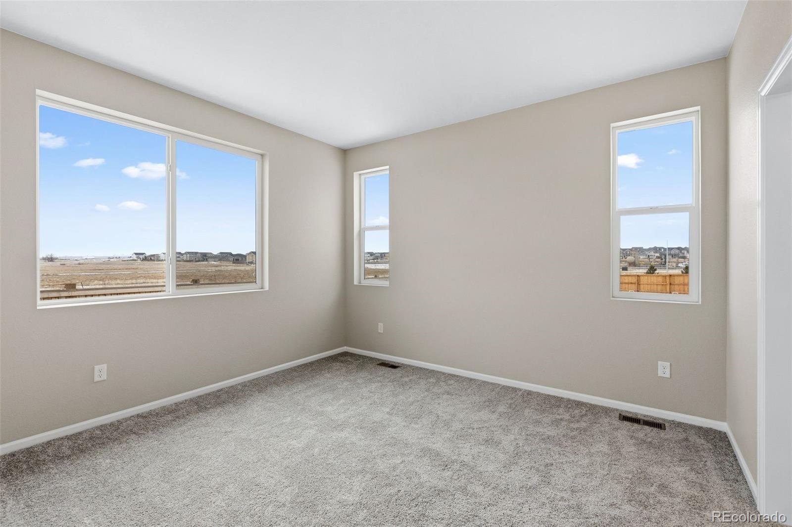 6028 Keyser Place Brighton, CO 80601 - Photo 10 of 26 an empty room with windows and closet