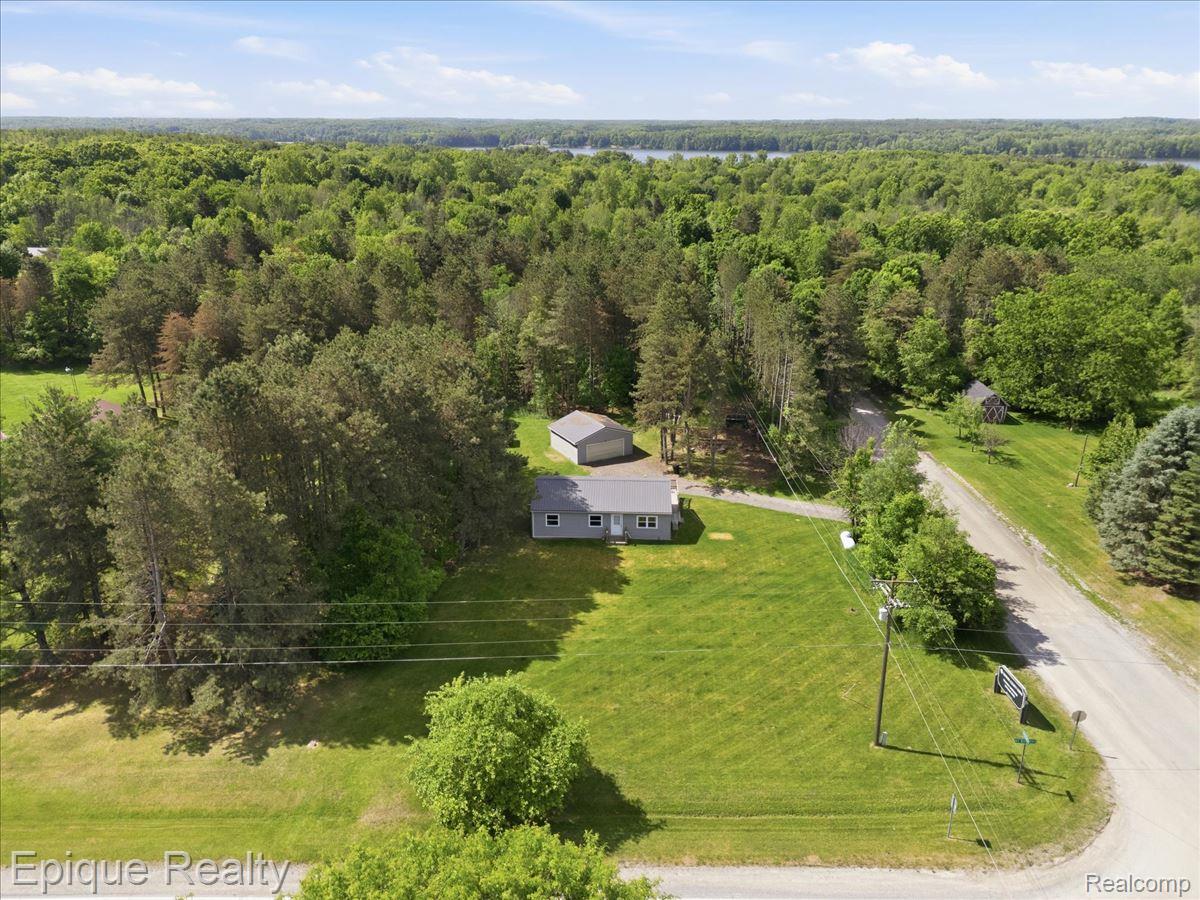 12272 East Mt Morris Road Davison, MI 48423 - Photo 36 of 39 Single-story residence set on a large grassy lot, featuring a detached garage and a separate shed