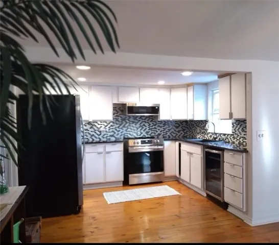 a bedroom with bed and wooden floor