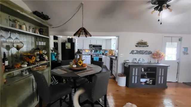 a view of a dining room with furniture and wooden floor