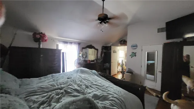 a bedroom with furniture and a closet