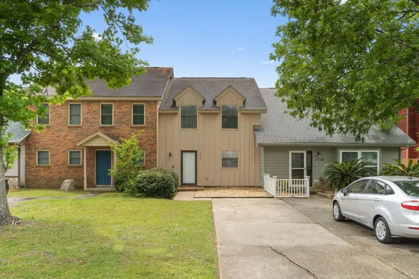 a front view of a house with a garden