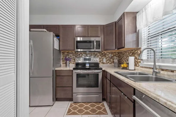 a kitchen with a sink stove and refrigerator