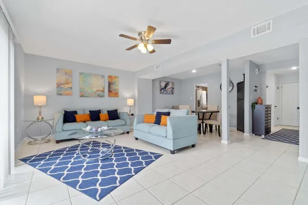 a living room with furniture and a dining table