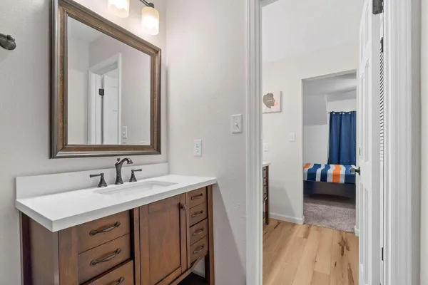 a bathroom with a sink vanity and mirror