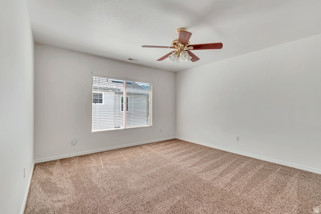 546 Wheatridge Road Tooele, UT 84074 - Photo 31 of 49 3rd Bedroom featuring neutral-toned carpet, white walls, and a ceiling fan with integrated lighting