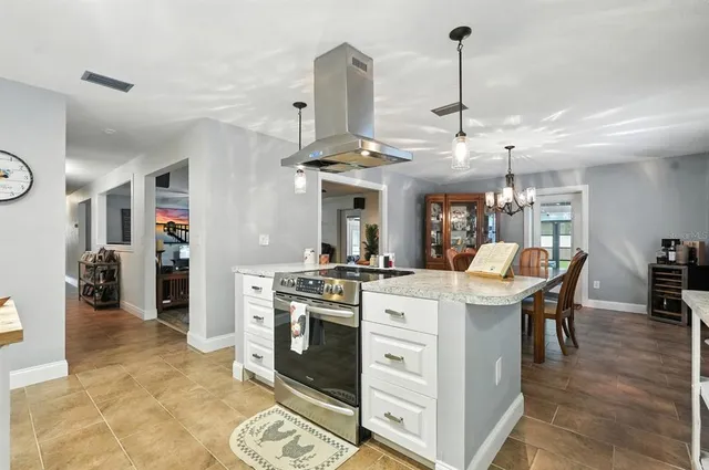 a kitchen with refrigerator and cabinets