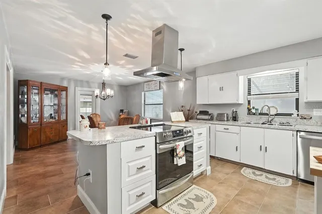a kitchen with stainless steel appliances a refrigerator sink and cabinets