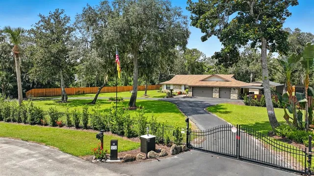 a front view of a house with a garden and yard