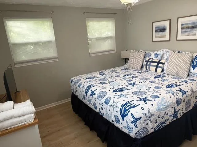 a bed sitting in a bedroom next to a window