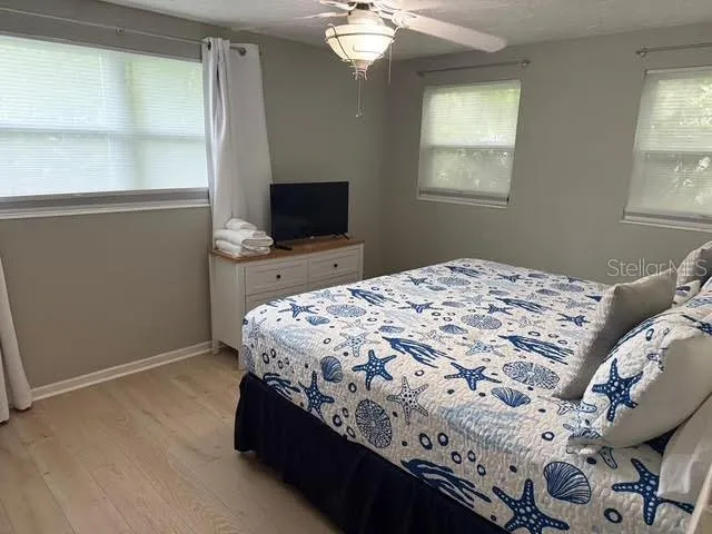 a bedroom with a bed and a flat screen tv