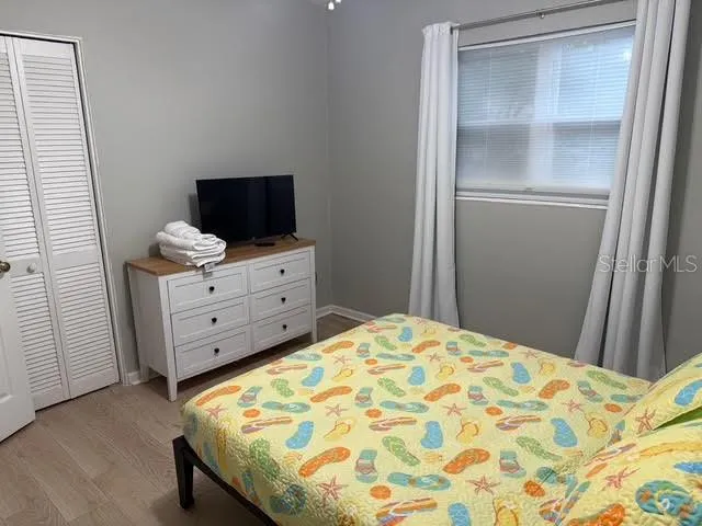 a bed sitting in a bedroom next to a window