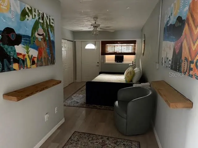 a view of a hallway with bathroom and wooden floor