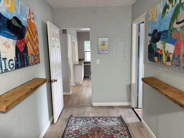 a bed sitting in a bedroom next to a lamp