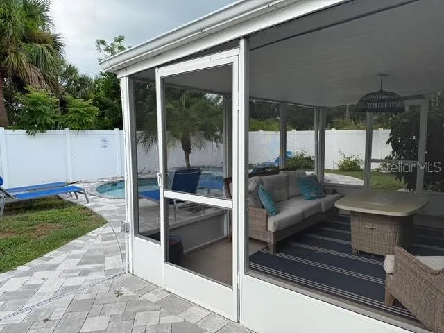 a view of living room with furniture and floor to ceiling windows