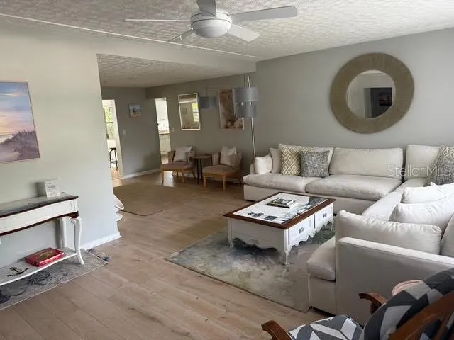 a living room with furniture a rug and a mirror