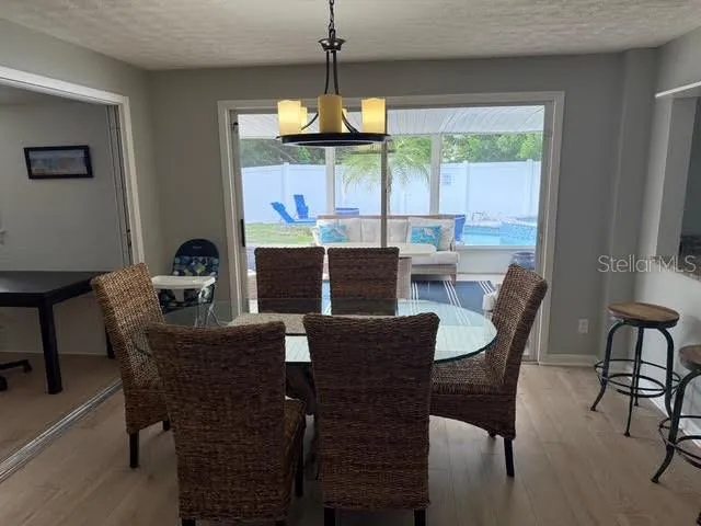 a dining room with furniture a chandelier and window