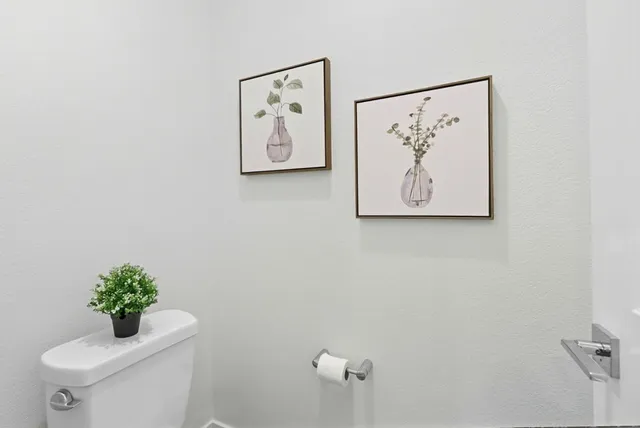 a white wall with a toilet