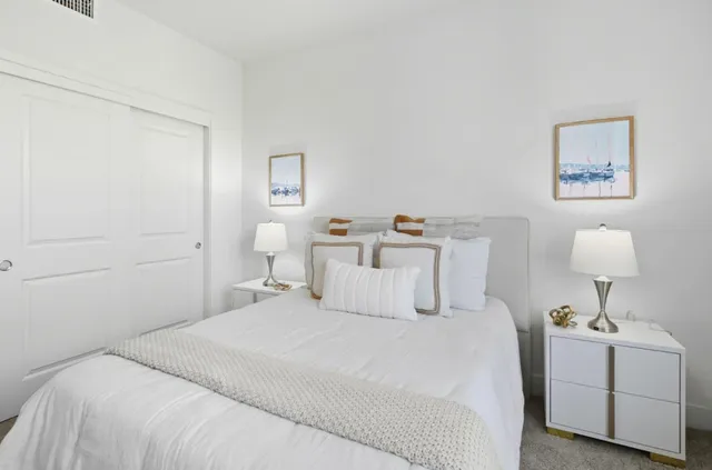 a bedroom with a bed and a lamp