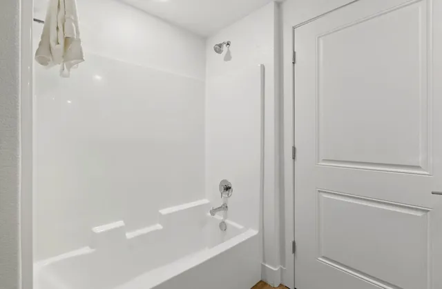 a bathroom with a bathtub and shower