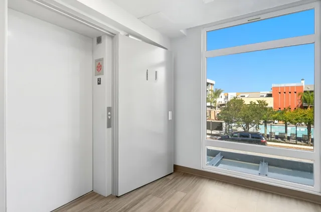 a view of a room with wooden floor and window