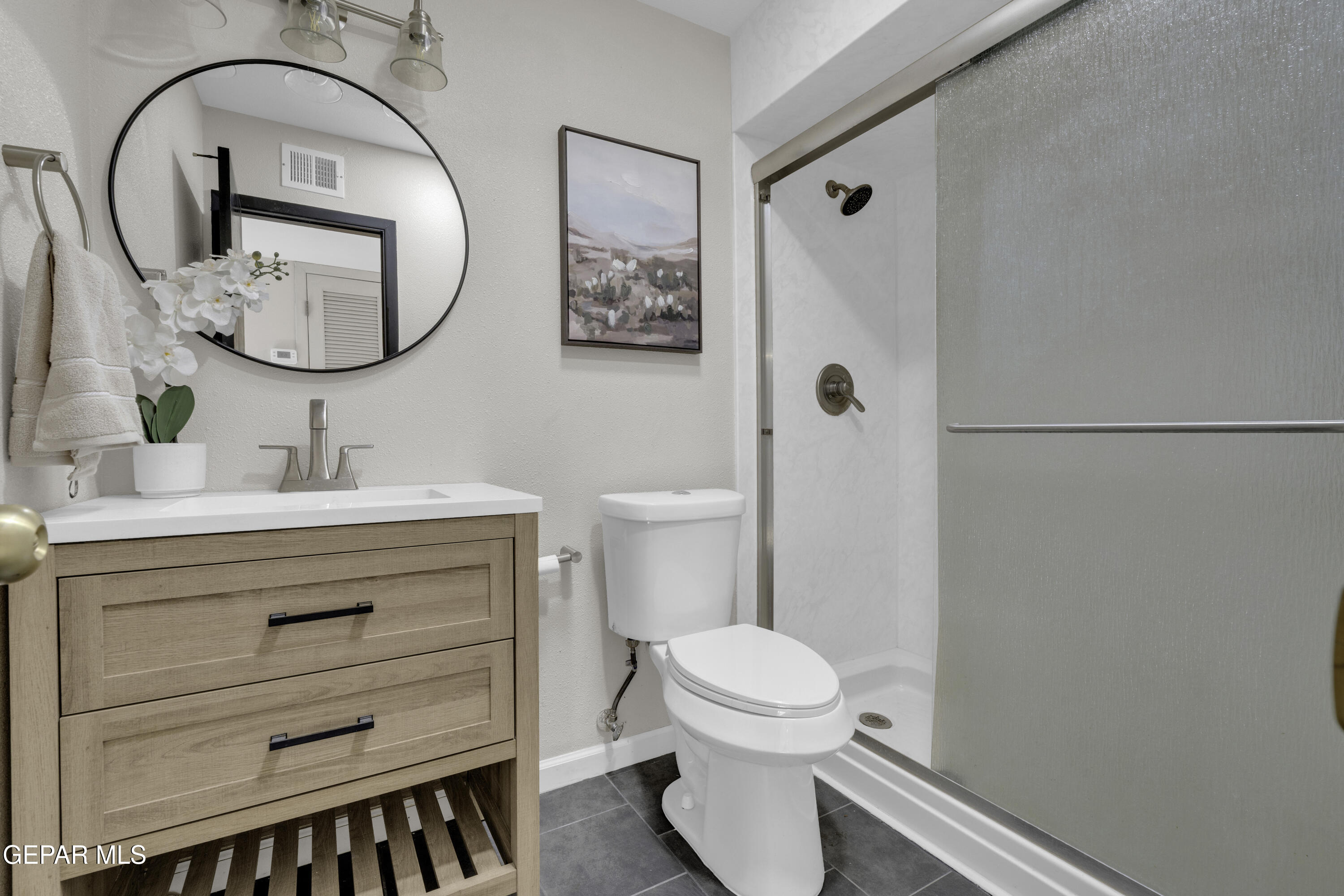 7125 Banana Tree Lane El Paso, TX 79915 - Photo 18 of 62 a bathroom with a sink a mirror a toilet and a mirror