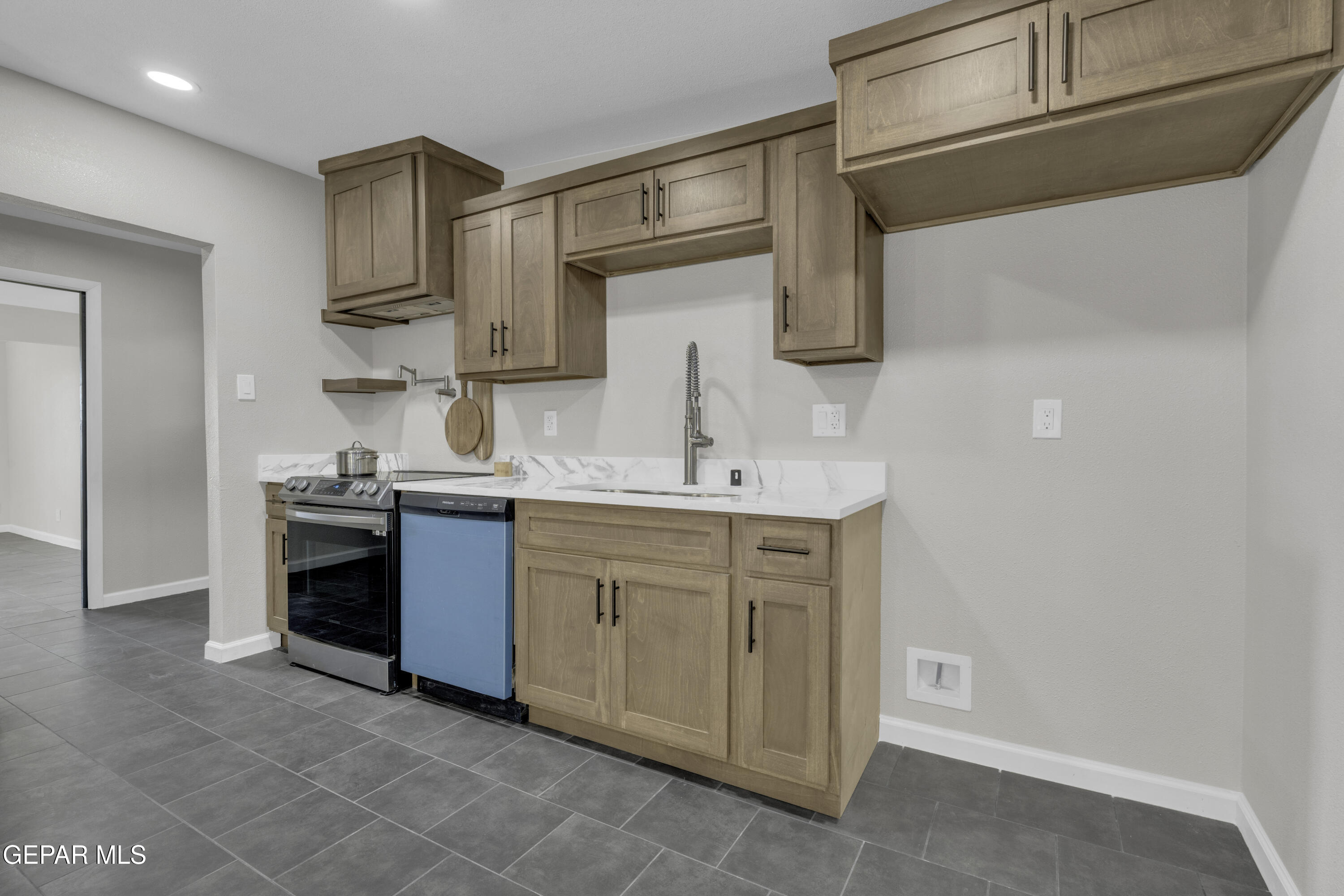 7125 Banana Tree Lane El Paso, TX 79915 - Photo 25 of 62 a kitchen with cabinets stainless steel appliances and a sink