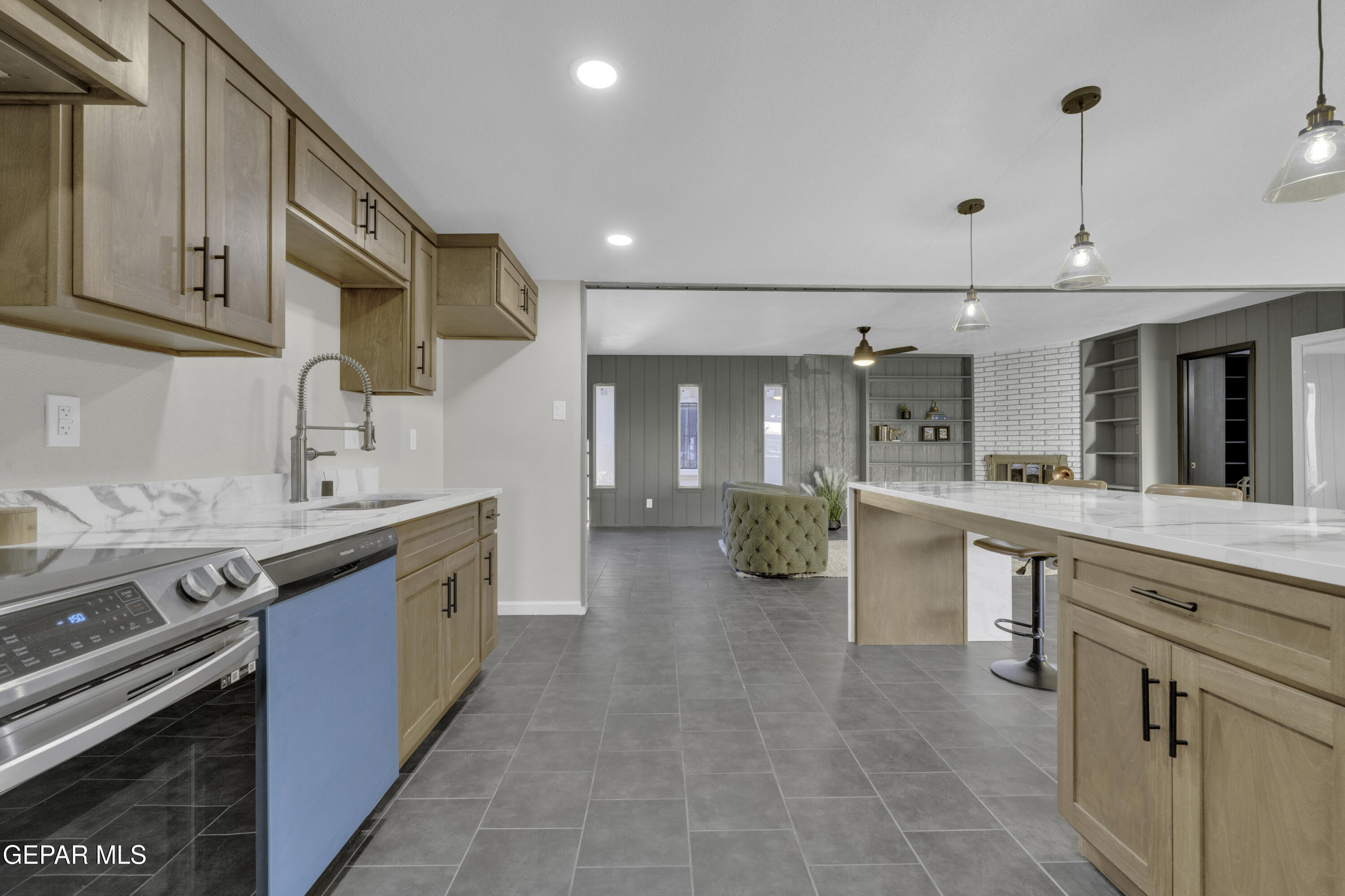 7125 Banana Tree Lane El Paso, TX 79915 - Photo 29 of 62 a large kitchen with stainless steel appliances granite countertop a sink and cabinets