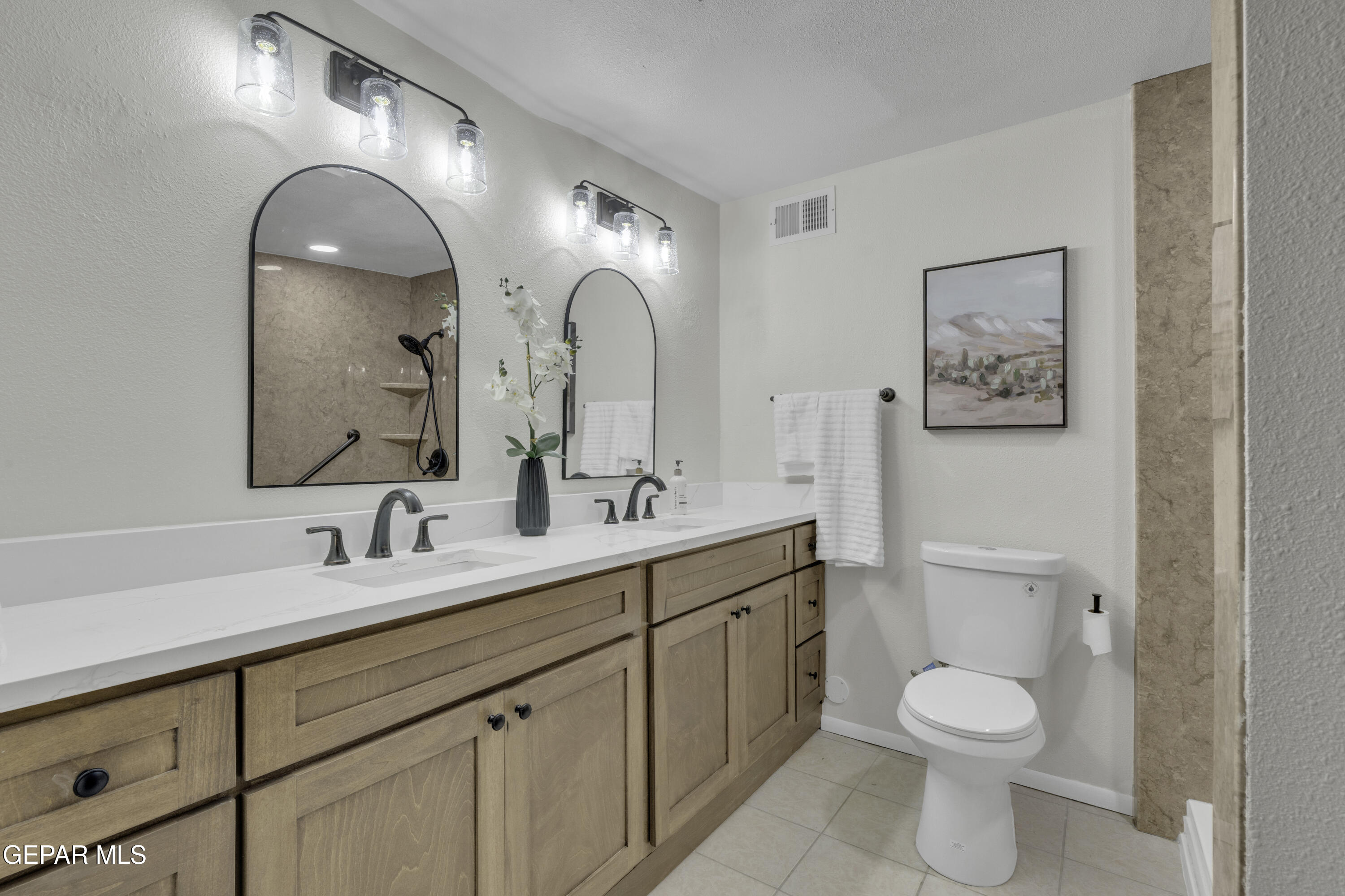 7125 Banana Tree Lane El Paso, TX 79915 - Photo 47 of 62 a spacious bathroom with a toilet sink and mirror