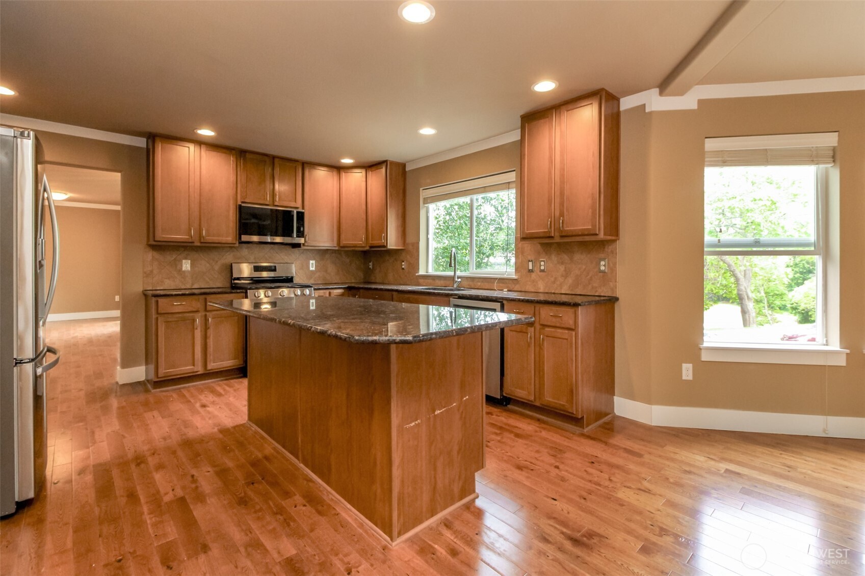 3000 South Mt Baker Boulevard Seattle, WA 98144 - Photo 13 of 40 a kitchen with stainless steel appliances granite countertop a sink a stove a refrigerator cabinets and a large window