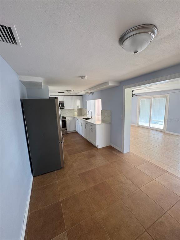3631 Grayton Drive New Port Richey, FL 34652 - Photo 11 of 42 a view of kitchen and refrigerator cabinets