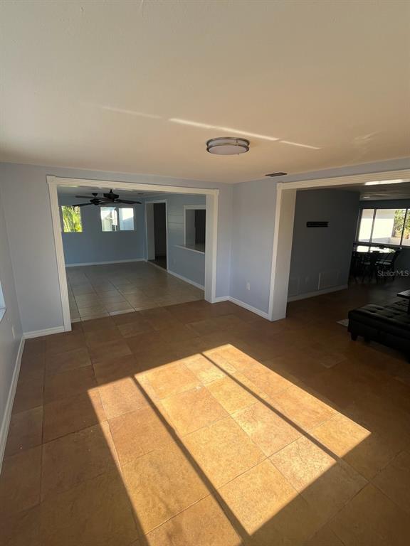 3631 Grayton Drive New Port Richey, FL 34652 - Photo 14 of 42 a view of a hallway with wooden floor and a living room