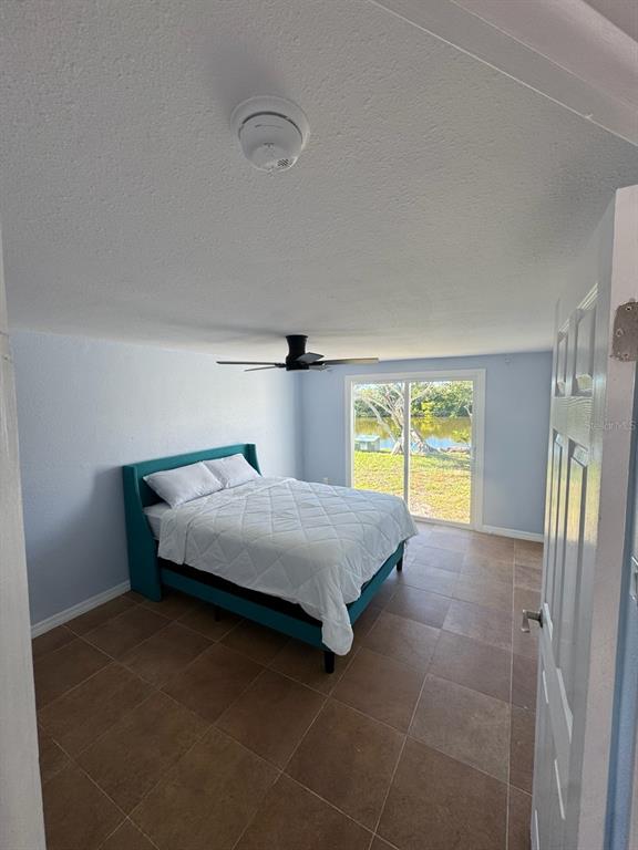 3631 Grayton Drive New Port Richey, FL 34652 - Photo 20 of 42 a bed sitting in a bedroom next to a window