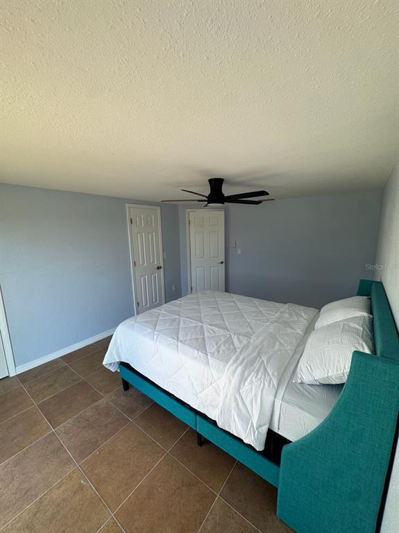 3631 Grayton Drive New Port Richey, FL 34652 - Photo 23 of 42 a bedroom with a bed and a night stand