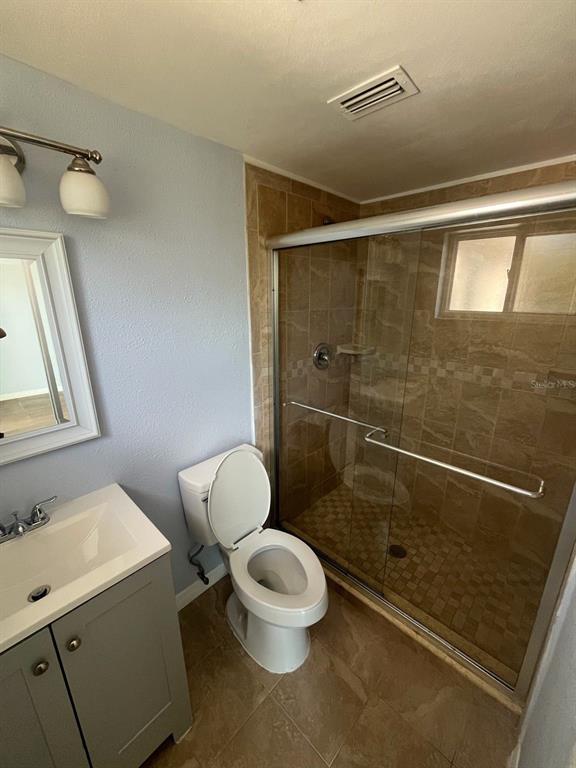 3631 Grayton Drive New Port Richey, FL 34652 - Photo 26 of 42 a bathroom with a toilet a sink and a shower
