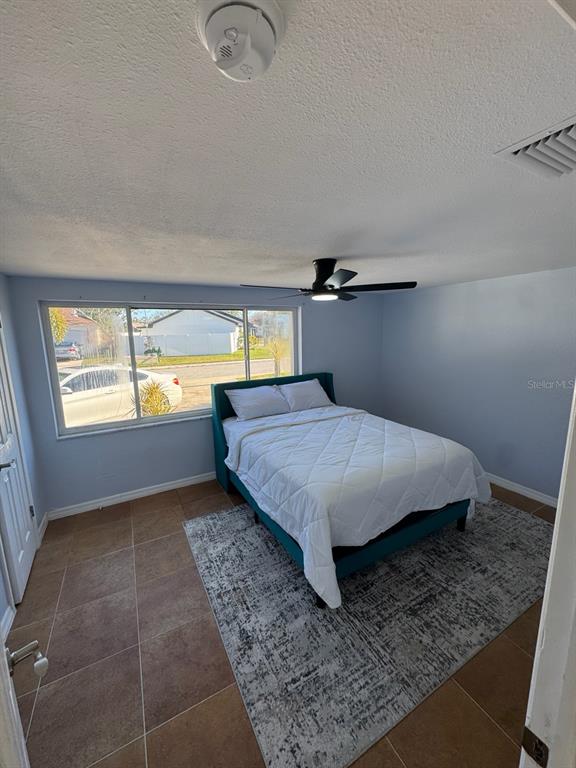 3631 Grayton Drive New Port Richey, FL 34652 - Photo 27 of 42 a bedroom with a bed and window