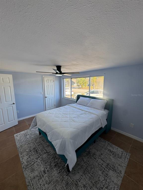 3631 Grayton Drive New Port Richey, FL 34652 - Photo 28 of 42 a bed sitting in a spacious bedroom next to a window