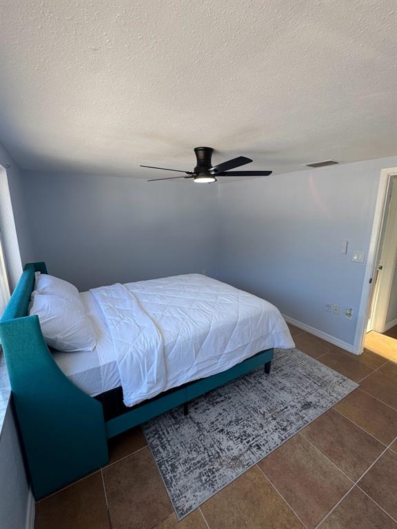 3631 Grayton Drive New Port Richey, FL 34652 - Photo 29 of 42 a bedroom with a bed and wooden floor