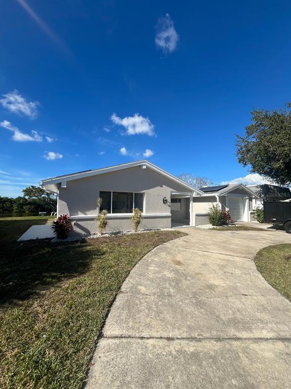 3631 Grayton Drive New Port Richey, FL 34652 - Photo 39 of 42 a front view of a house with a yard and garage