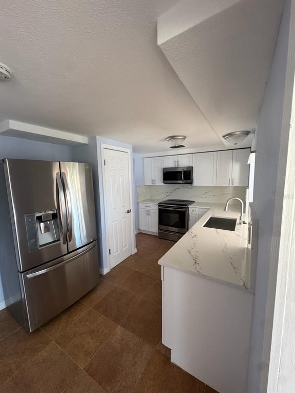 3631 Grayton Drive New Port Richey, FL 34652 - Photo 8 of 42 a kitchen with a refrigerator sink and oven